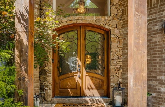 front porch, stone front porch, wood beams, front door, picture window, brick home exterior
