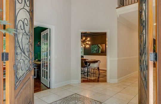 front door view into entryway, tile flooring, door to office