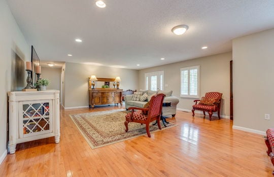 living room, recessed lighting, hardwood flooring, front door