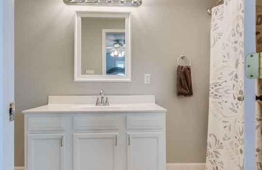 primary bathroom, tile flooring, sink, shower/tub