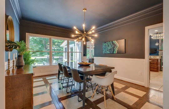 dinign room, door to kitchen tile and hardwood flooring, windows