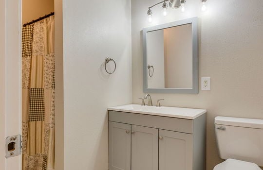 lower level bathroom, tile flooring, toilet, sink, shower