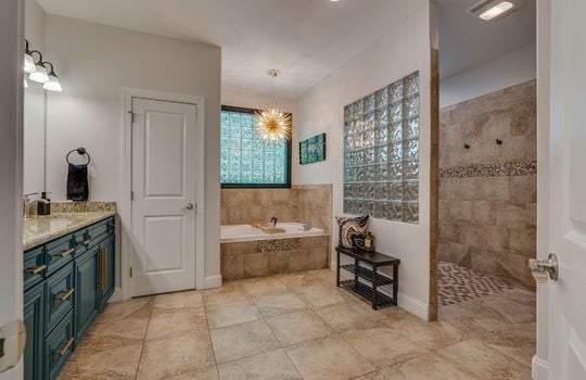 bathroom, dual vanity, cabinet, linen closet, soaking tub, tile shower, tile flooring