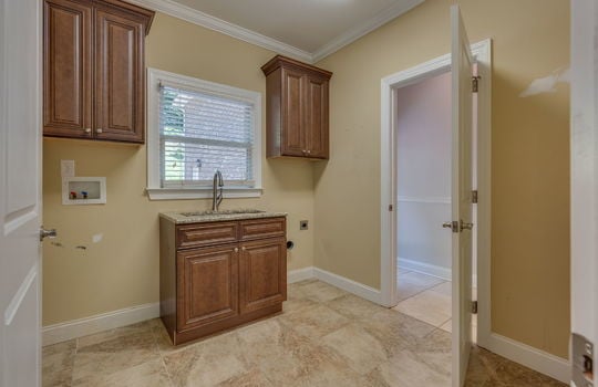 second laundry room, cabinets, sink, washer & dryer hookups, tile flooring