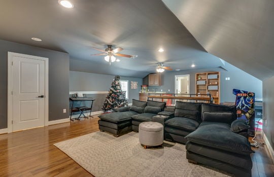 media/game room, ceiling fans, recessed lighting, hardwood flooring, windows