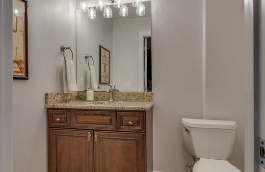 ensuite bathroom, tile flooring, granite countertop, cabinet, toilet
