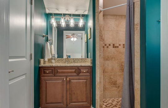 bathroom, tile flooring, tile shower, granite coutnertop