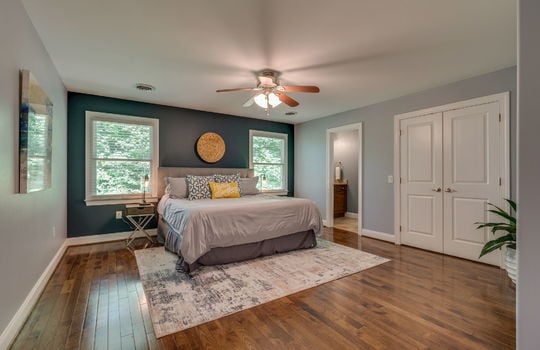 bedroom, hardwood flooring, windows, closet, door to ensuite bathroom, ceiling fan