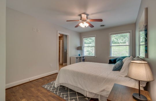 bedroom, hardwood flooring, ceiling fan, windows, door to ensuite bathroom