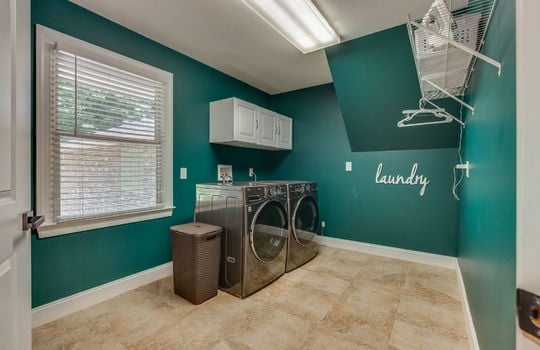 laundry room, tile flooring, washer/dryer hookups, shelving, overhead cabinets