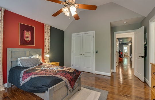 bedroom, closet, hardwood flooring, vaulted ceiling, ceiling fan, door