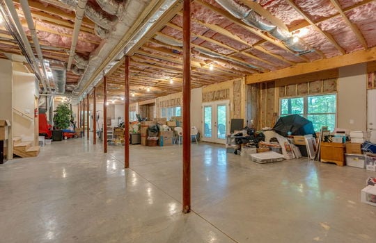unfinished basement, concrete flooring, stairs to main level