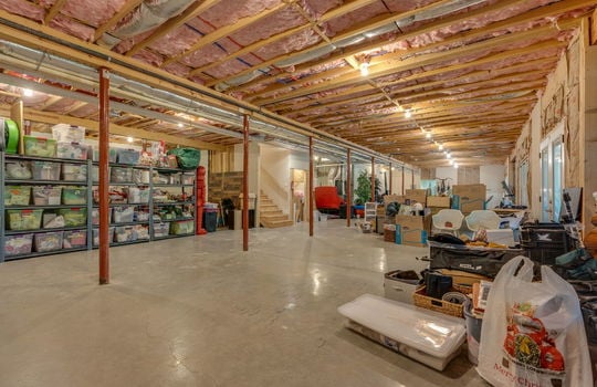 unfinished basement, concrete flooring, stairs to main level