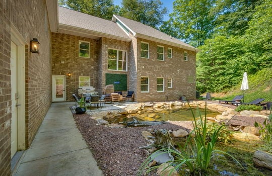 back patio, exterior doors, back yard, rock pond, rock waterfall, brick home exterior