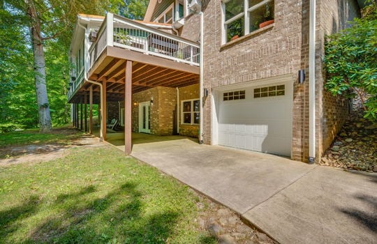 garage door, driveway, covered back deck, brick exterior, back deck
