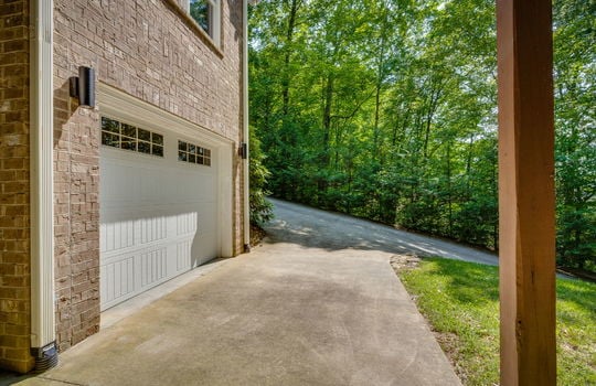 garage, driveway, garage door, brick exterior