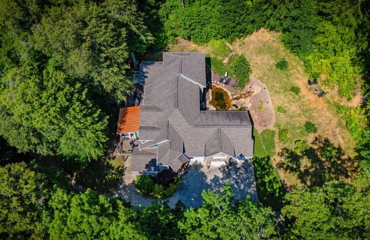 aerial view from front of property, roof, driveway, back yard, pond, trees