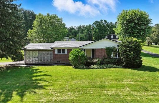front yard, brick ranch, landscaping, driveway, carport, neighboring homes