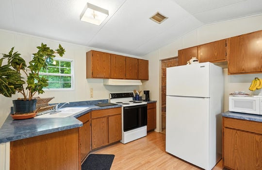 kitchen, refrigerator, cabinets, countertops, sink, oven/range, laminate flooring