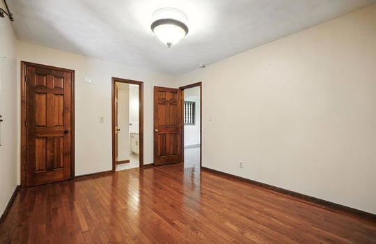 bedroom, primary bedroom, closet, primary bathroom, hardwood flooring, wood trim, wood doors