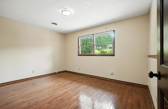 bedroom, window, hardwood flooring wood trim, wood door