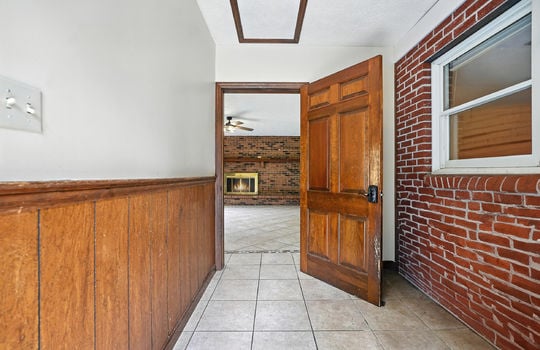 foyer, tile flooring, attic access, interior door