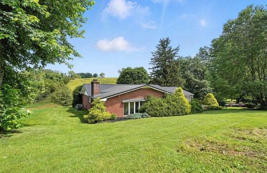 back side view of home, brick ranch, back yard, trees, landscaping