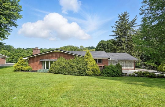 brick ranch, back of home, metal roof, back yard, landscaping, mountain views