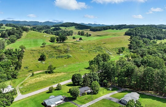 aerial photo of home, neighboring homes, mountains, roads