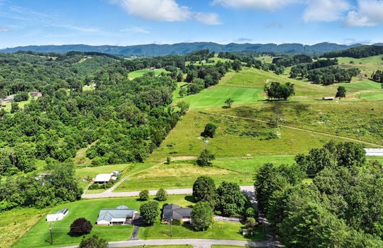 aerial photo of home, neighboring homes, mountains, roads
