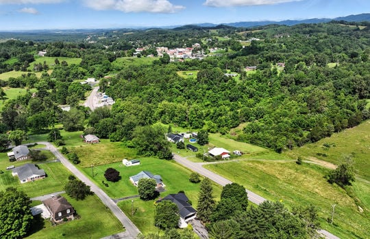 aerial photo of home, neighboring homes, mountains, roads