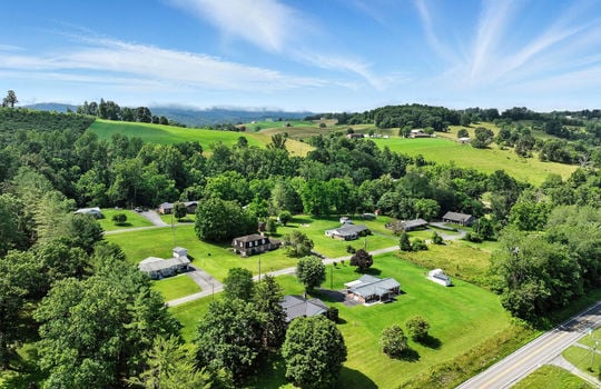 aerial photo of home, neighboring homes, mountains, roads