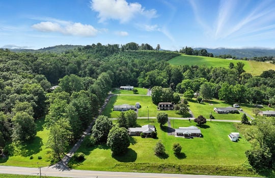 aerial photo of home, neighboring homes, mountains, roads