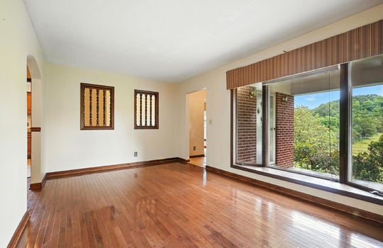 formal living room, picture windows, mountain views, hardwood flooring, doorway to foyer