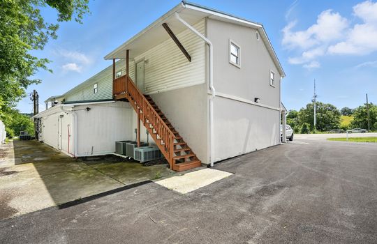 upper level apartment, stairs, vinyl siding, door