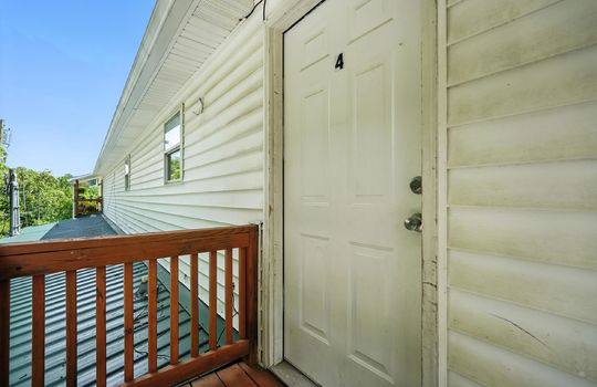 upper level apartment door, vinyl siding