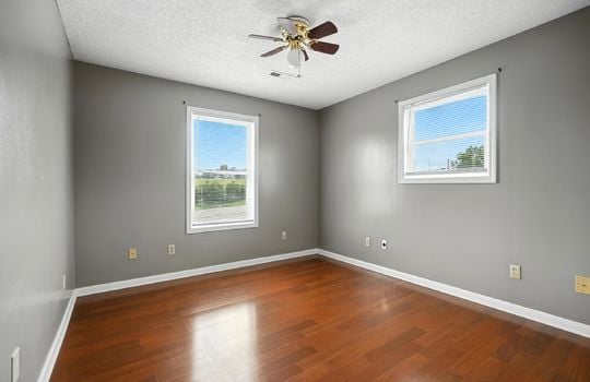 bedroom, laminate flooring, windows, ceiling fan