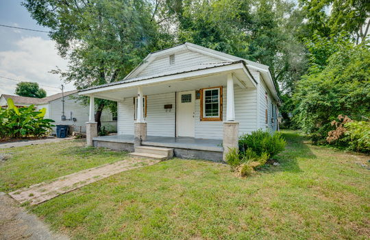 bungalow, cottage, covered front porch, front door, metal roof, sidewalk