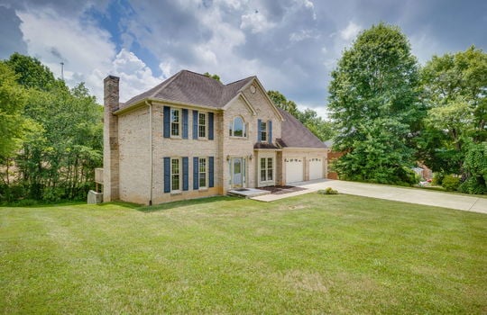 Two story, traditional, brick home, front yard, front door, driveway, two car garage, trees