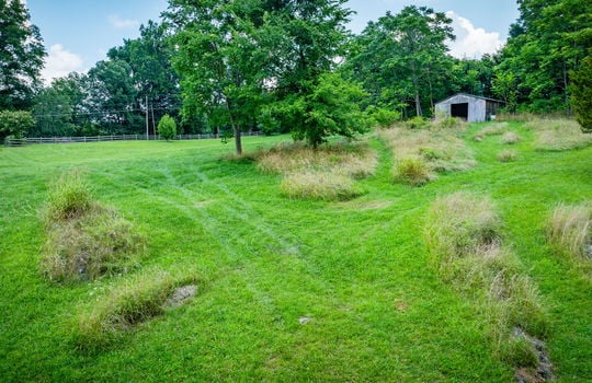 cleared land, shed, fence, trees