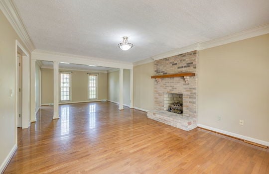 formal living area, hardwood flooring, brick fireplace