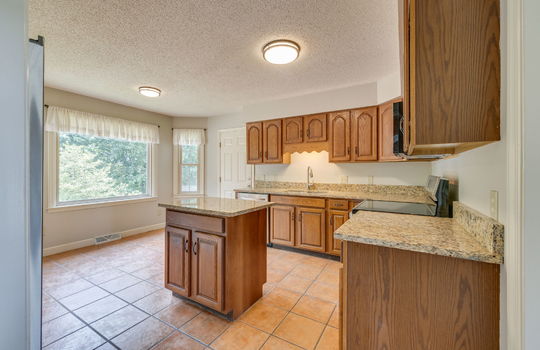 Kitchen, granite countertops, cabinets, stove/oven, refrigerator, sink, dishwasher, built-in microwave, tile flooring