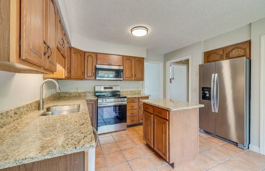 kitchen, tile flooring, cabinets, granite countertops, refrigerator, oven/range, built in microwave, dishwasher, sink