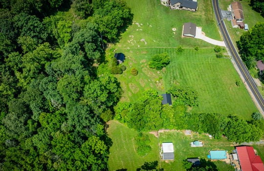 aerial photo of property, road, trees, shed, cabin, neighboring homes