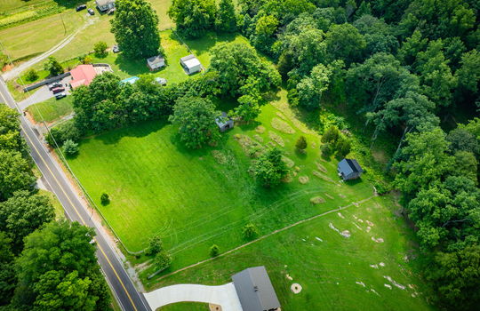 aerial photo of property, road, trees, shed, cabin, neighboring homes