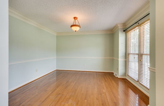 formal dining room, hardwood flooring, windows, chair railing