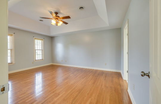bedroom, tray ceiling, ceiling fan, windows, hardwood flooring