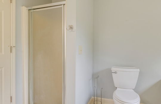primary bathroom, shower, toilet, tile flooring