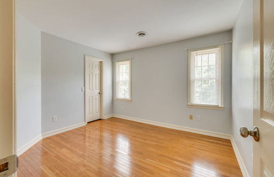 bedroom, hardwood flooring, closet, windows