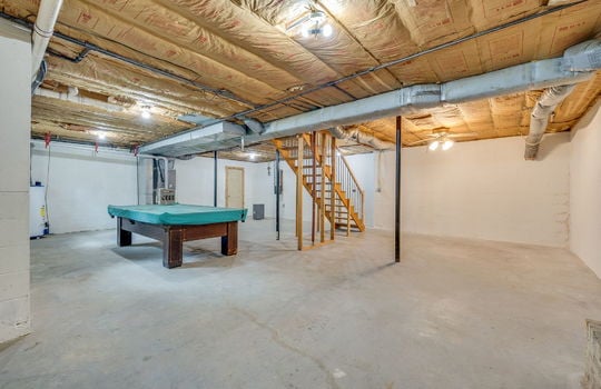 basement, unfinished basement, concrete flooring, stairs to main level, fireplace, exterior door, windows